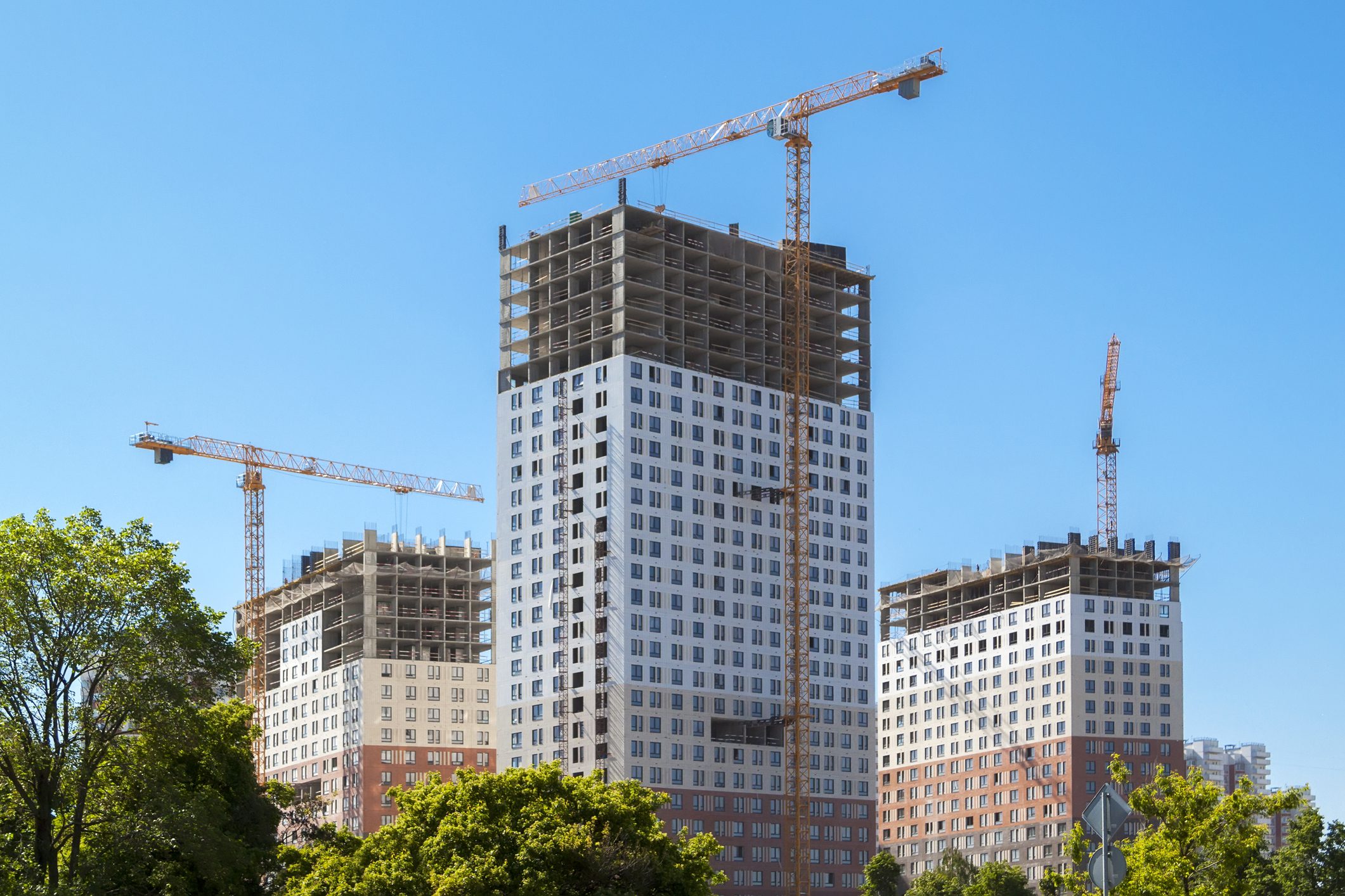 Construction site with cranes and tall buildings.