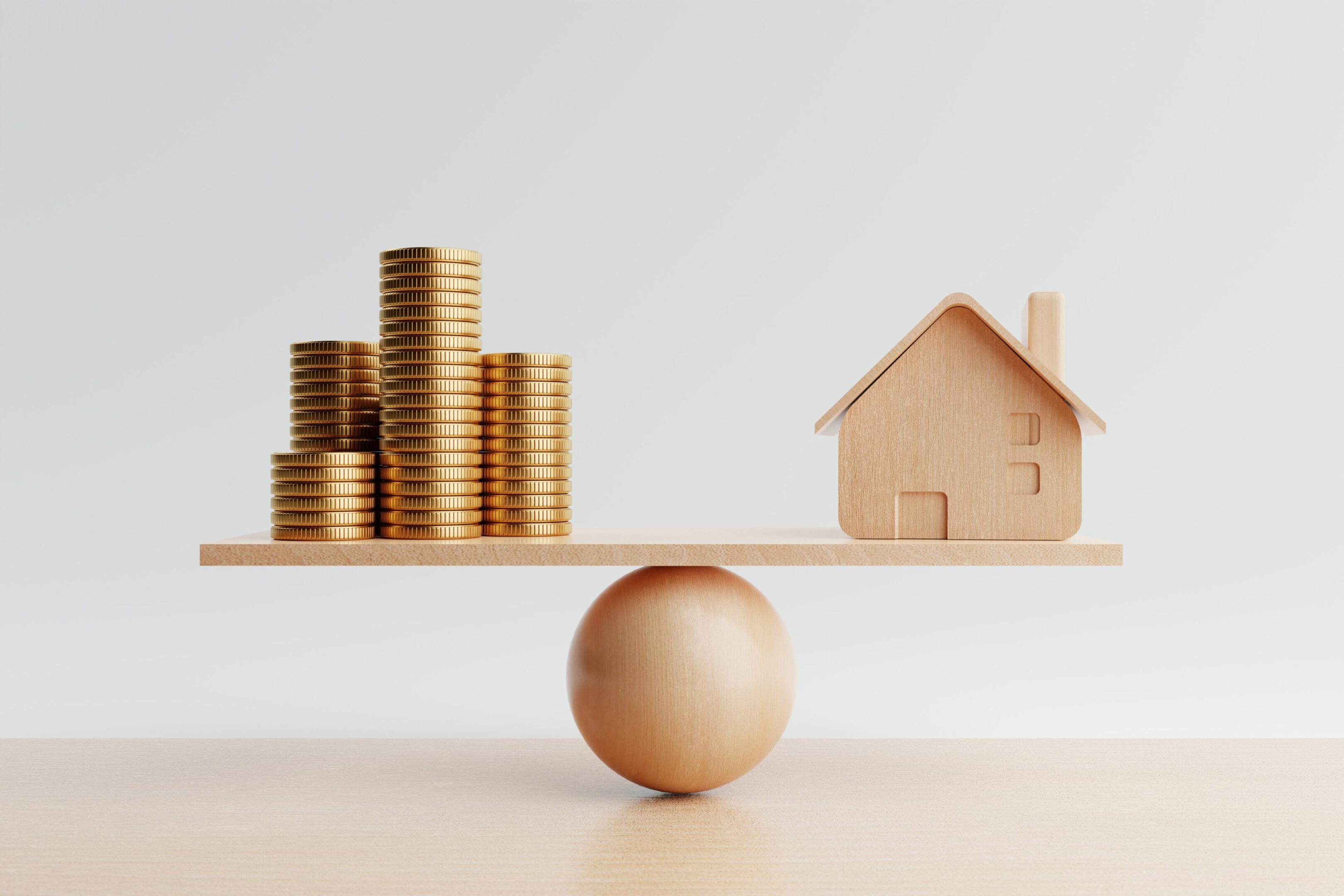 Coins and house balancing on wooden plank.