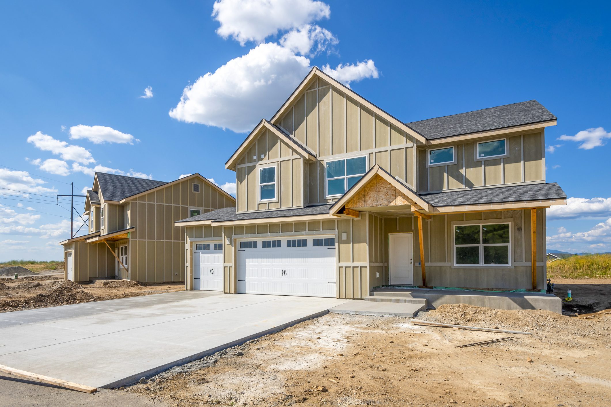 Modern two-story house under clear blue sky.